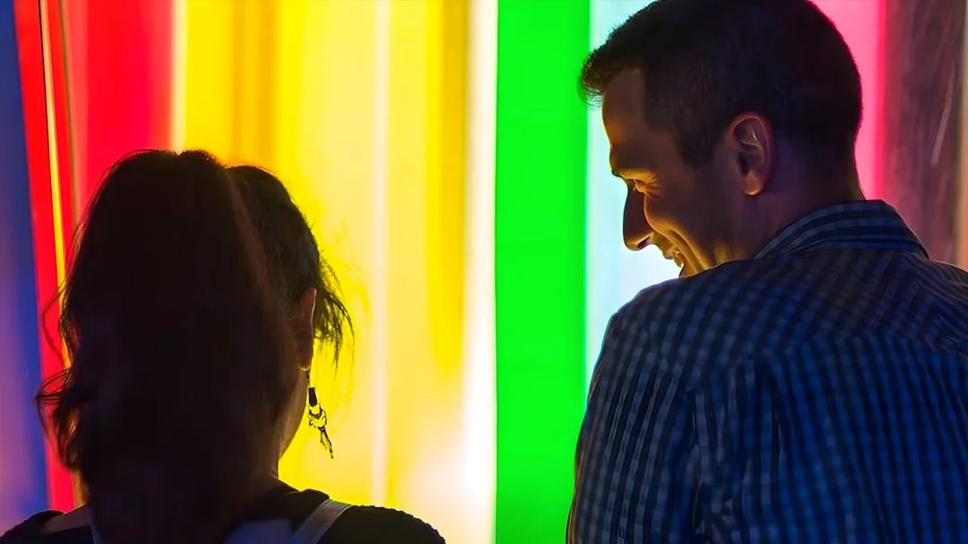 Visitors enjoying colorful light exhibit at the Exploratorium, San Francisco.