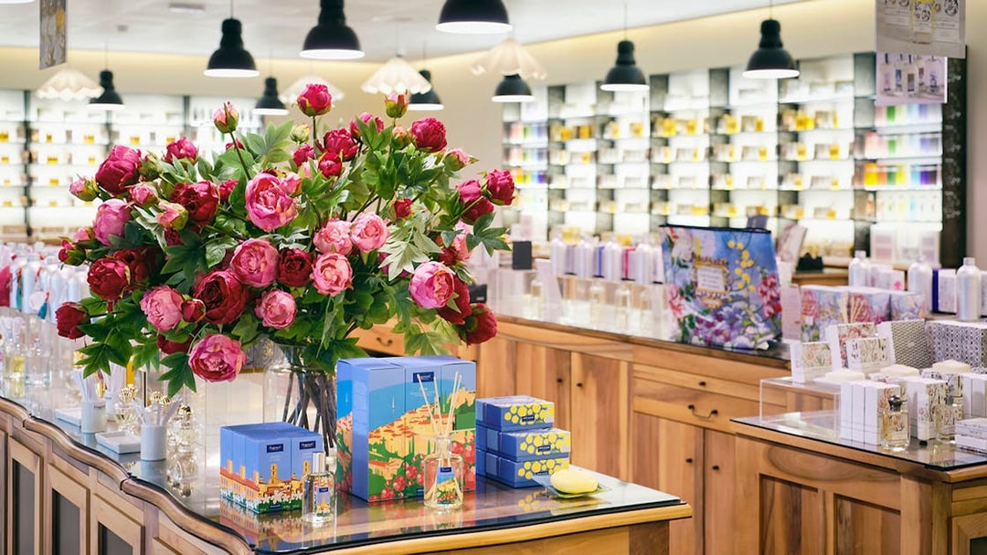 Fragonard Perfume Factory display with Flower of the Year eau de toilette and floral arrangement.