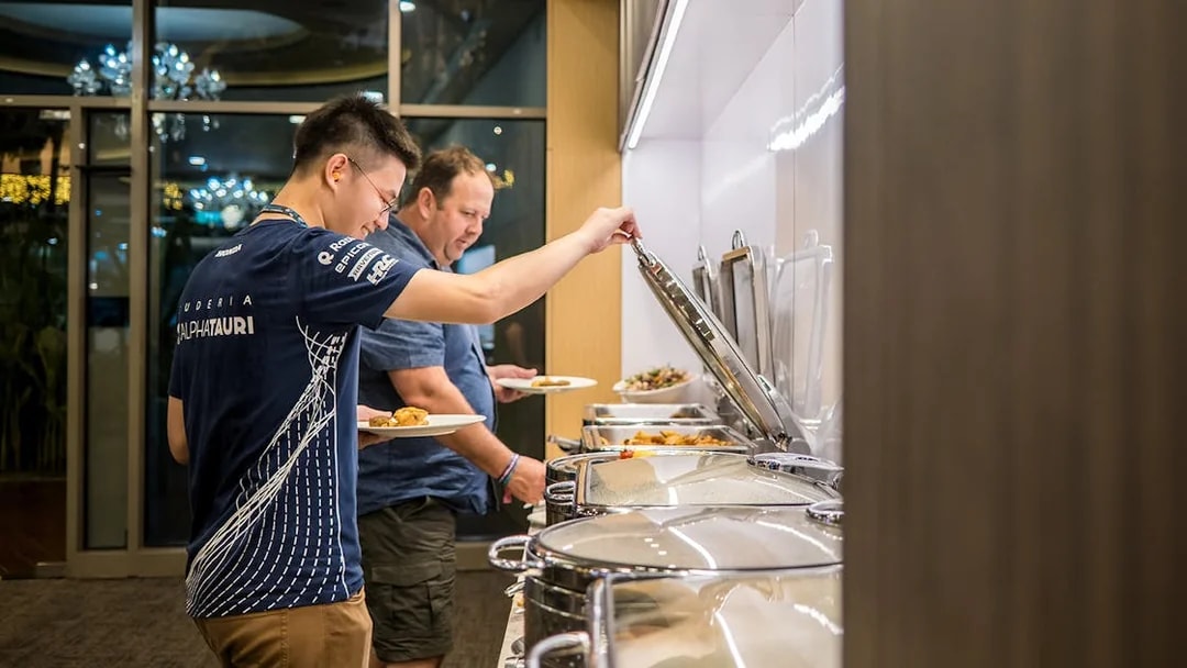 Guests enjoying buffet at Formula 1 Singapore Grand Prix 2025 hospitality suite.