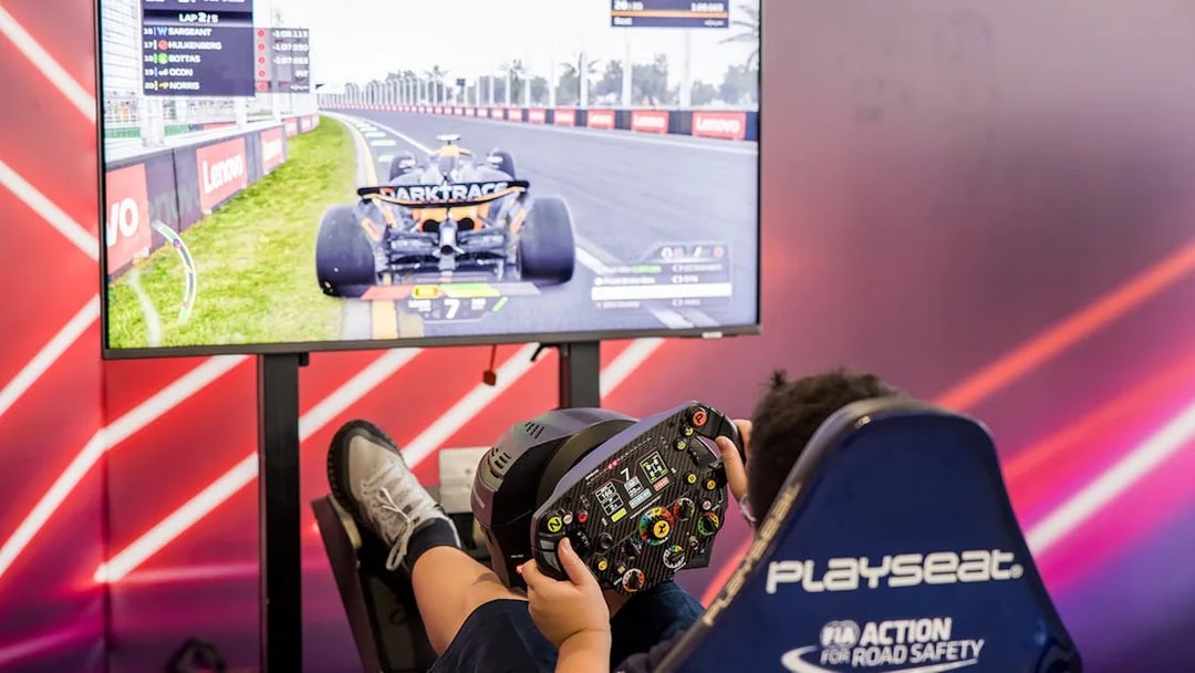 Person using a racing simulator at Formula 1 Singapore Grand Prix 2025 hospitality package.