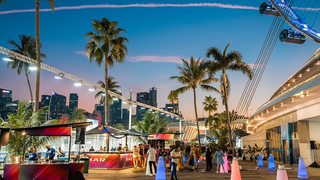 Hospitality area at Formula 1 Singapore Grand Prix 2025 with city skyline and palm trees.