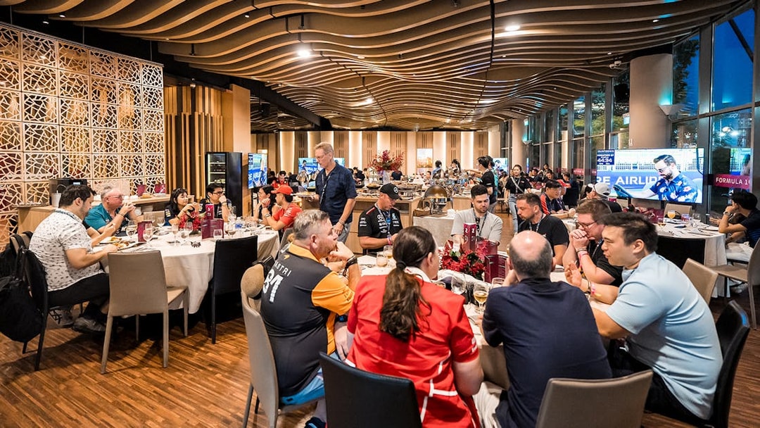 Guests dining in a luxurious suite at the Formula 1 Singapore Grand Prix 2025 hospitality event.
