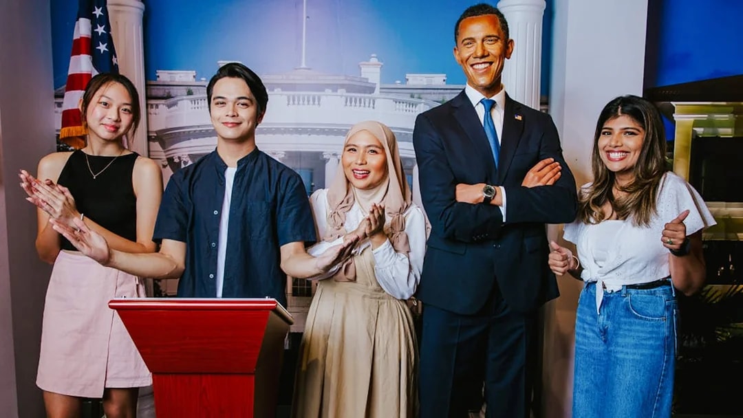 Visitors with Obama wax figure at Madame Tussauds Singapore.