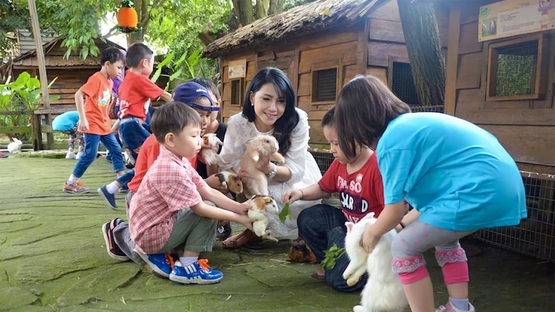 Children interacting with rabbits and guinea pigs at Farm In The City.
