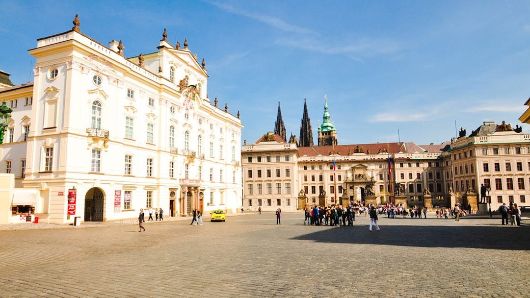 Prague Castle courtyard with tourists exploring historic architecture.