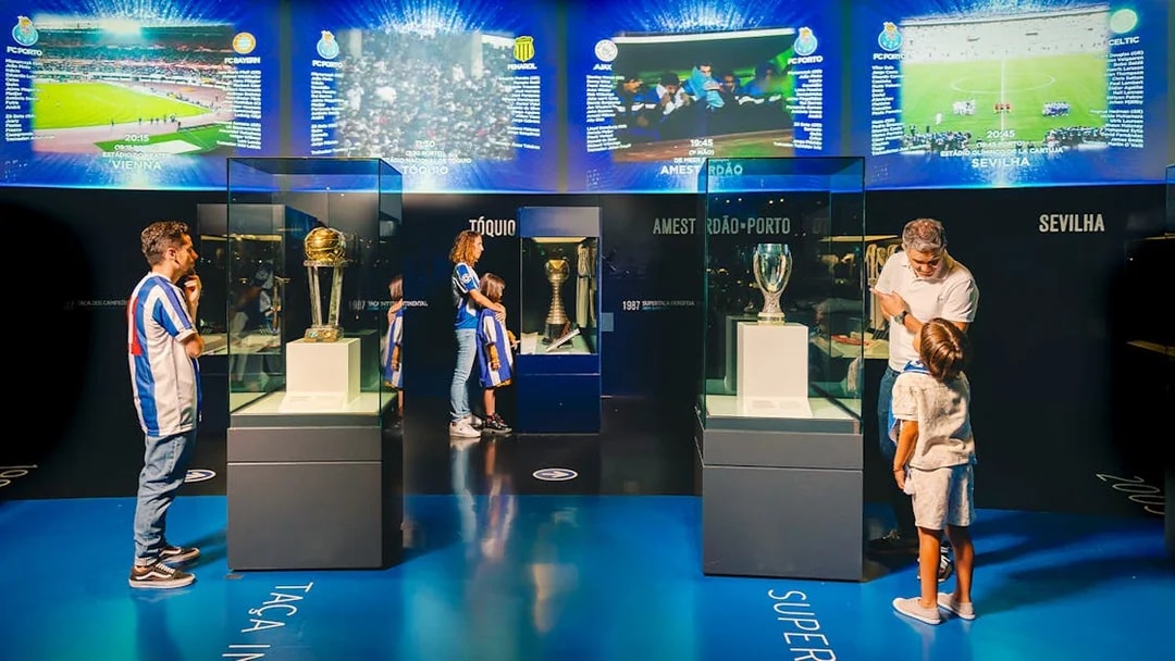 Visitors at FC Porto stadium museum viewing trophies in the trophy room.