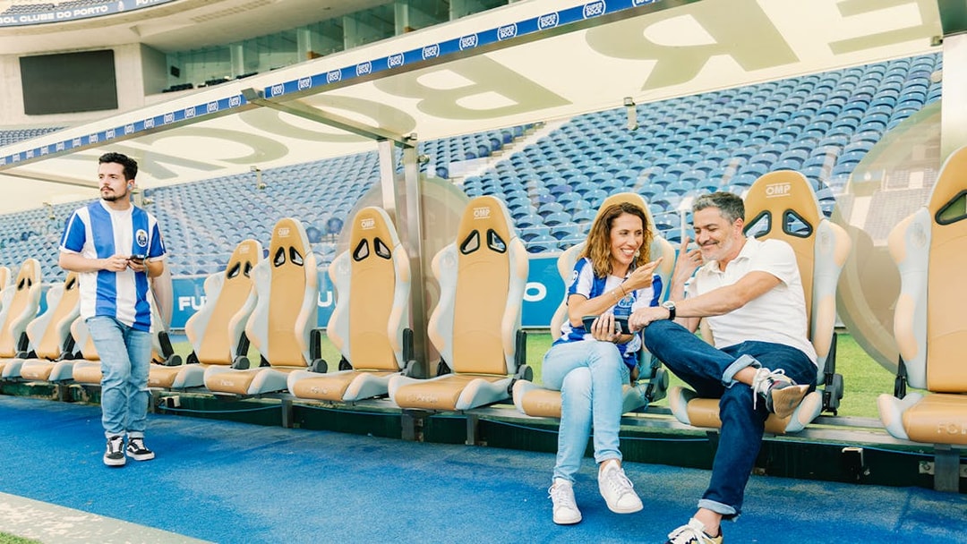 Visitors at FC Porto stadium museum exploring the team bench area.