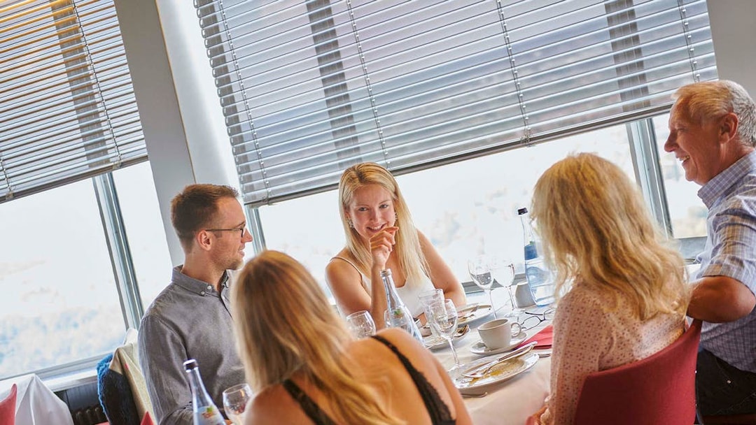 Dining experience at Fernsehturm Stuttgart with a group enjoying a meal.