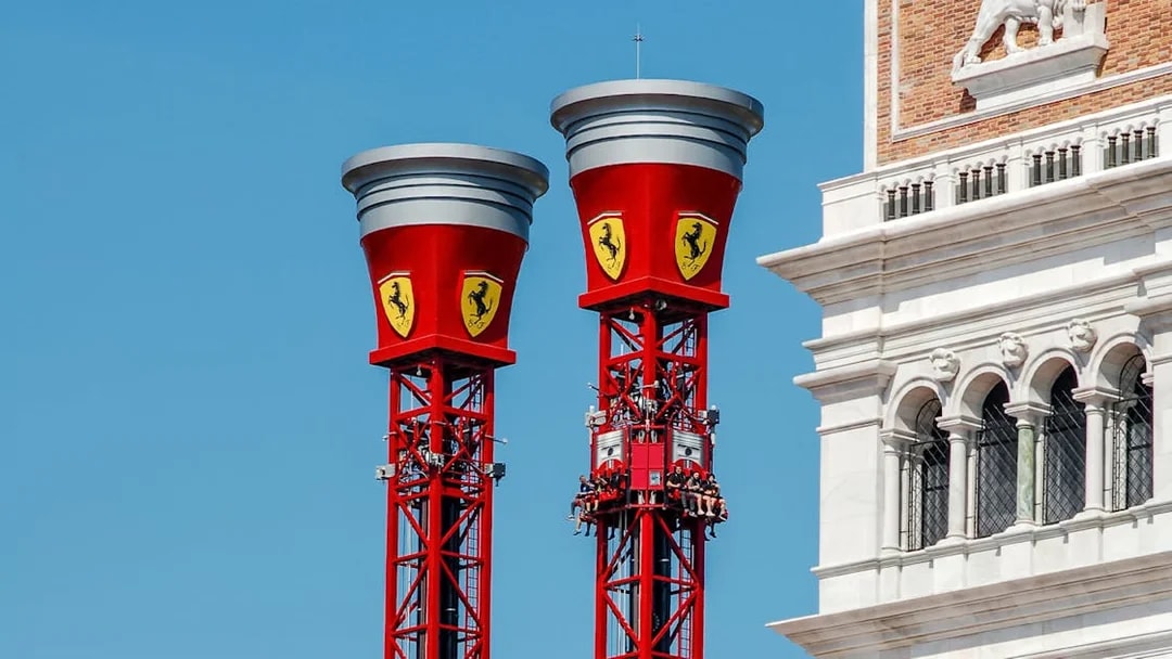 Thrill Towers ride at Ferrari Land with people ascending in red towers.