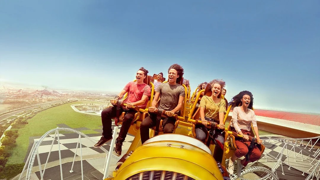 Visitors enjoying a roller coaster ride at Ferrari World Abu Dhabi.