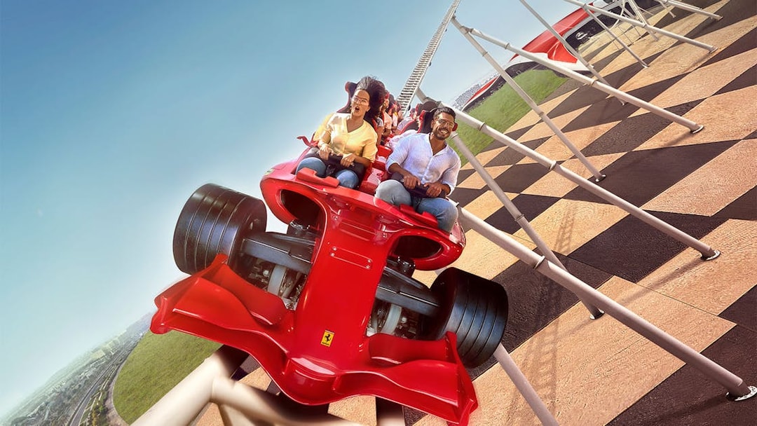 Roller coaster ride at Ferrari World Abu Dhabi with passengers enjoying the thrill.