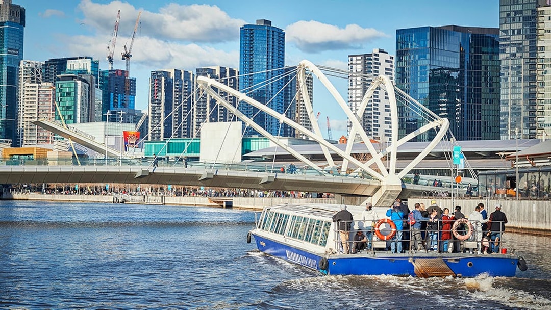 Ferry cruise on Yarra River with Melbourne skyline and Seafarers Bridge in view.