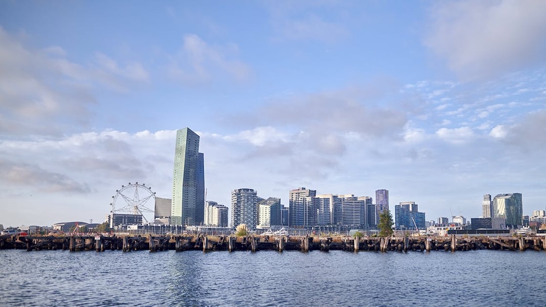 Melbourne skyline with Ferris wheel and waterfront view from Williamstown Ferry Cruise.