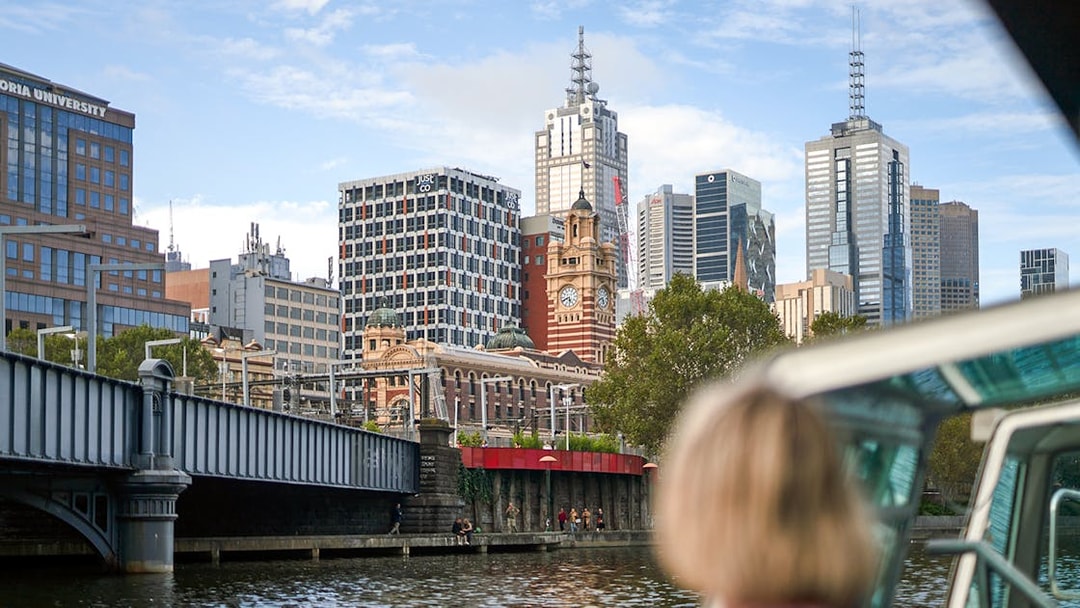 Guest viewing Melbourne skyline from a river cruise.