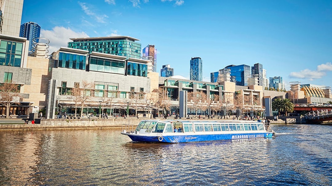 Ferry cruising on the Yarra River with Melbourne cityscape in the background.
