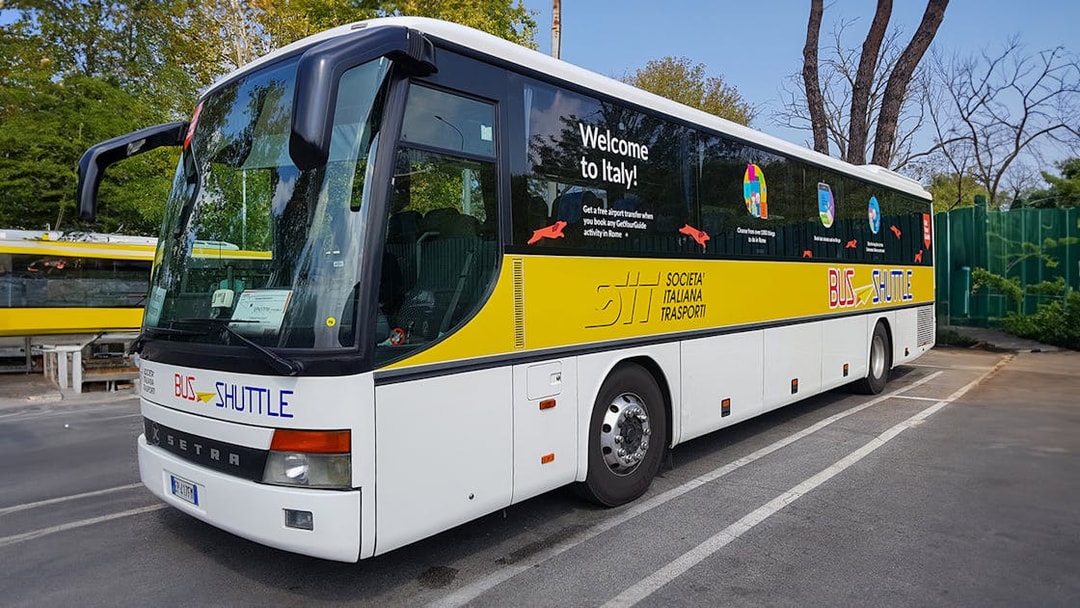 SIT Bus Shuttle parked in a lot, offering transport services in Italy.