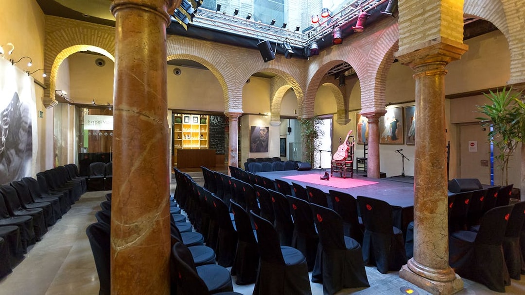 Flamenco Dance Museum stage set for a flamenco show with seating and arches.