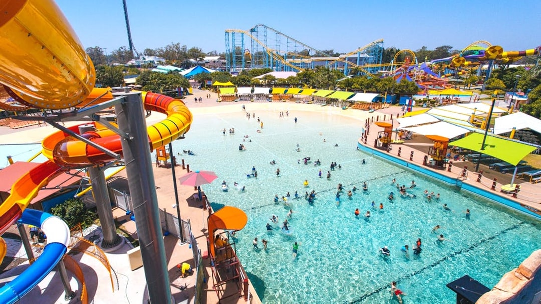 People enjoying wave pool and water slides at Whitewater World, Gold Coast.