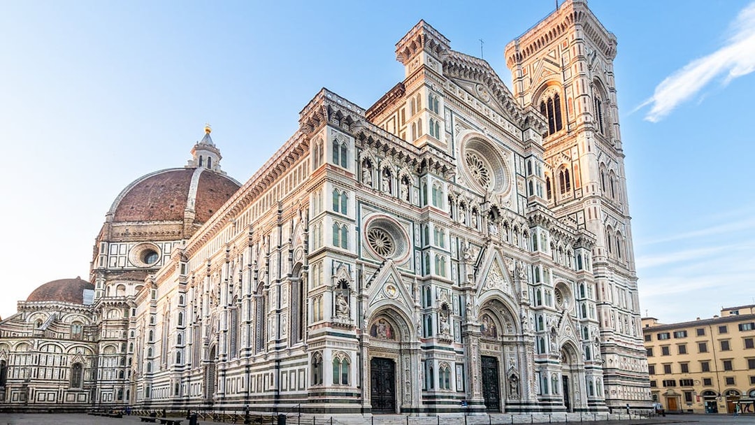 Florence Duomo with dome and bell tower under clear sky.