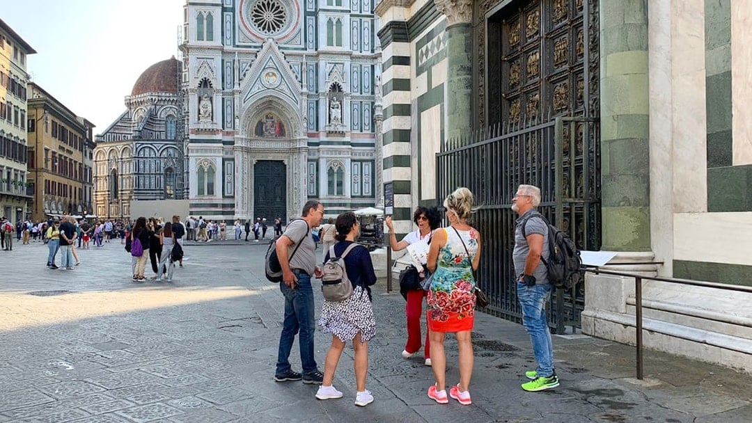 Tour group with guide outside Duomo Florence, Italy.