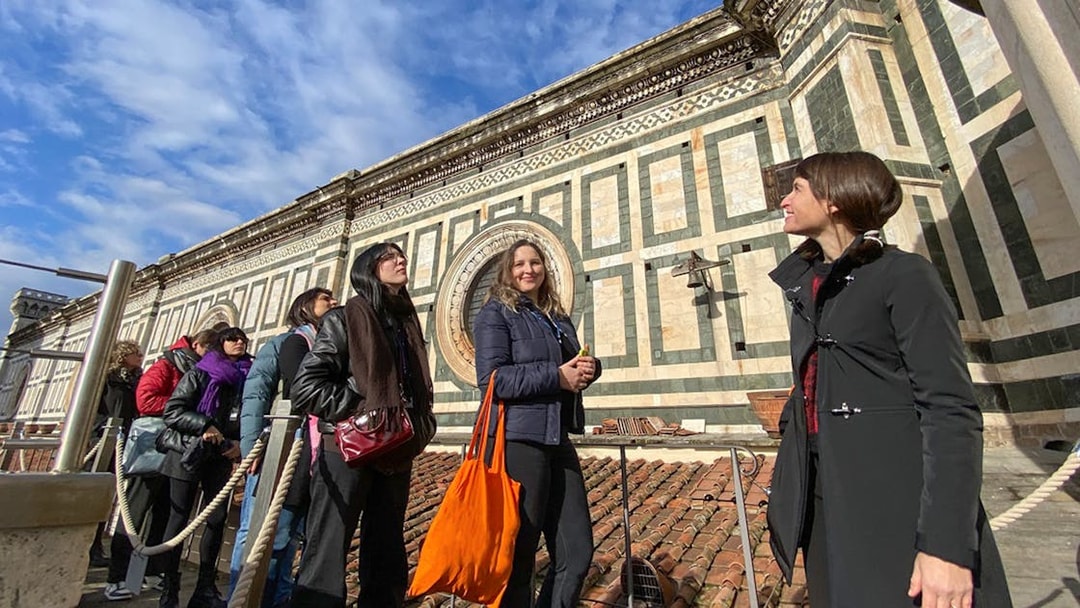 Visitors with a guide on the terrace of Florence Cathedral, Italy.