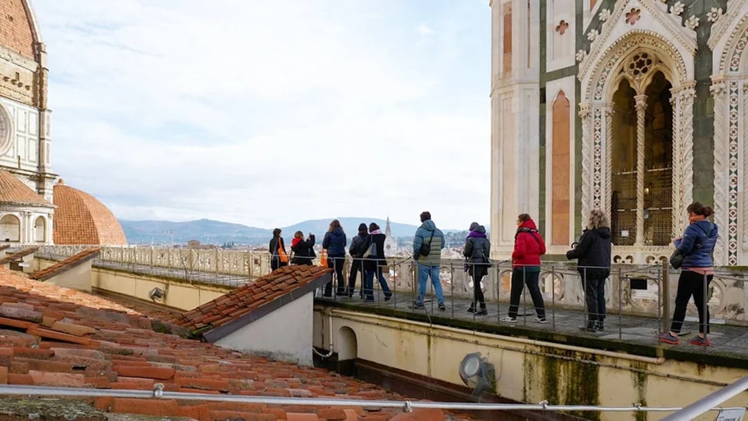 Visitors with a guide on the terrace of Florence Cathedral, Italy.