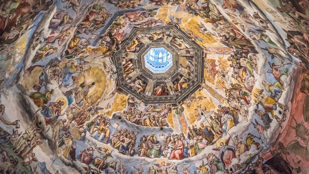 Frescoes inside Florence Duomo's dome, depicting religious scenes, viewed during the Express Guided Tour.