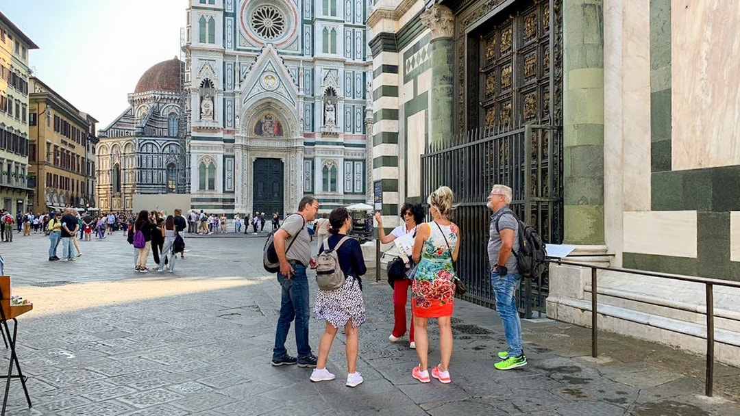 Tourists with guide near Florence Duomo, Italy.