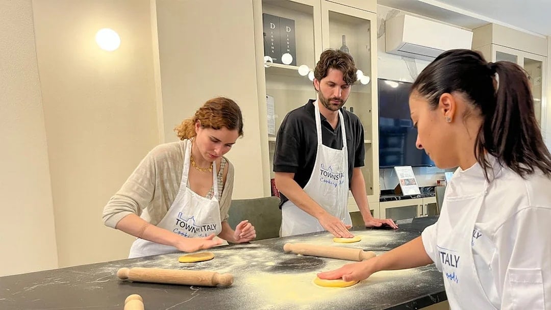 Participants making pasta in a Florence cooking class.