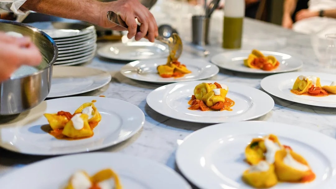Plating tortellini during a Florence pasta-making class.