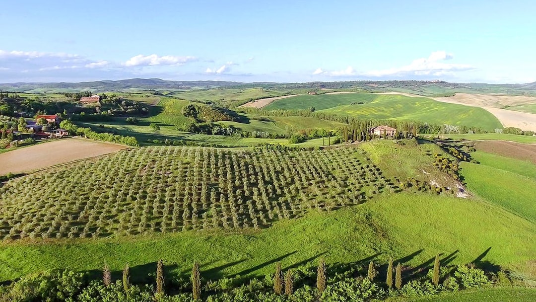 Aerial view of Chianti winery with vineyards and Tuscan landscape.