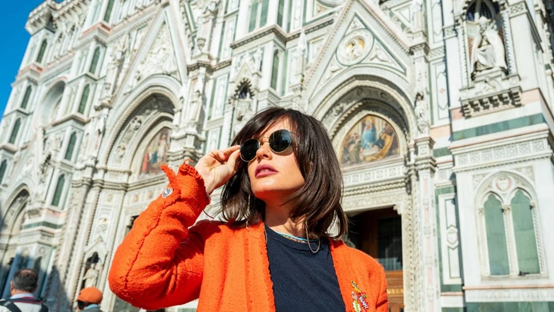 Woman posing outside the Duomo in Florence, Italy.