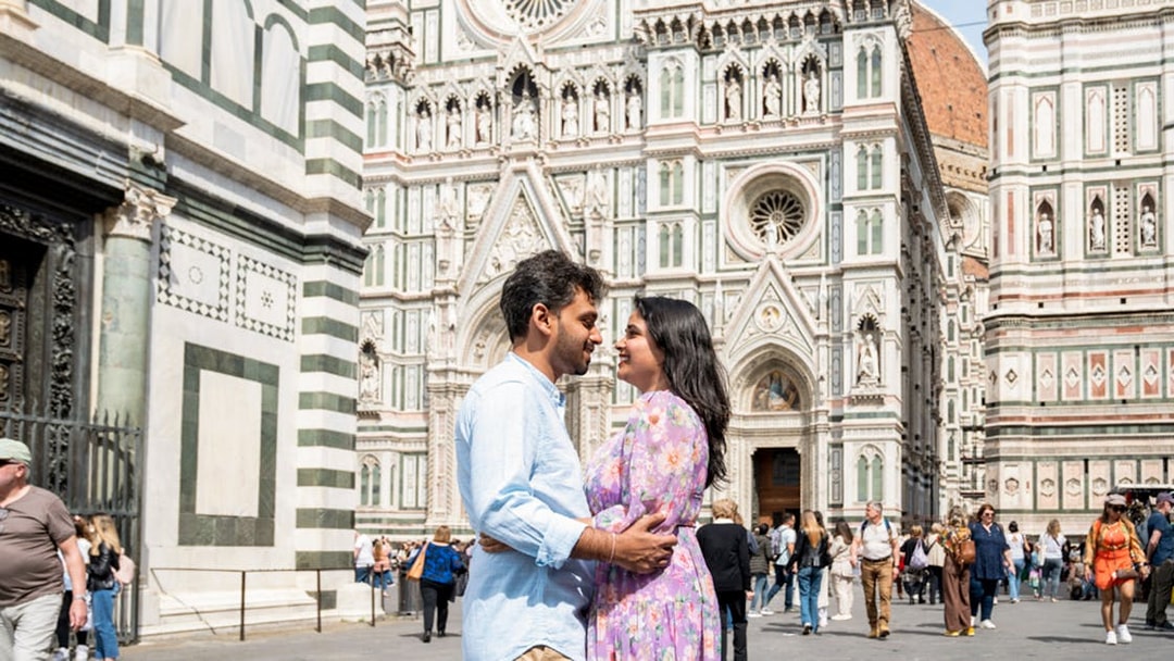 Couple embracing in front of the Duomo in Florence, Italy.
