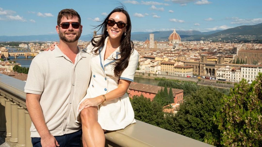 Couple enjoying a Florence tour with a view of the city and the Duomo in the background.