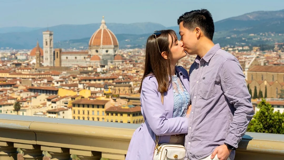 Couple kissing with Florence skyline and Duomo in the background.