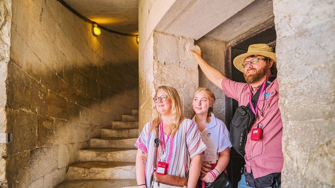 Guests exploring the interior staircase of the Leaning Tower of Pisa.