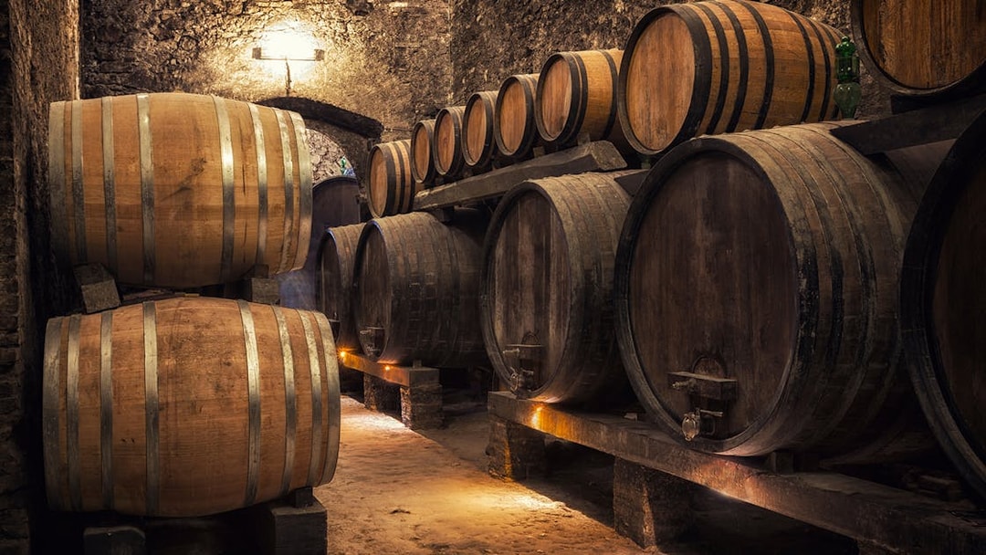 Wine barrels in a Tuscan cellar on the Tuscany Wine and Olive Oil Trail tour from Florence.