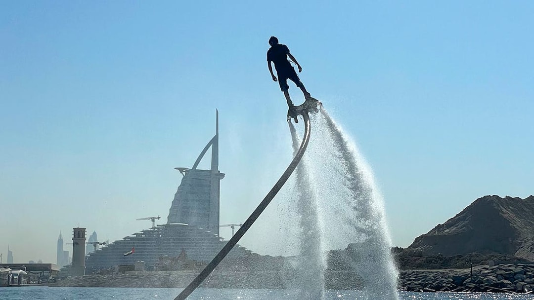 Flyboarding in Dubai with Burj Al Arab in the background.