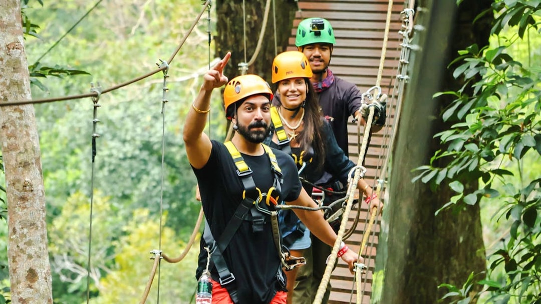 Participants on a zipline platform at Flying Hanuman, Phuket, wearing safety gear.