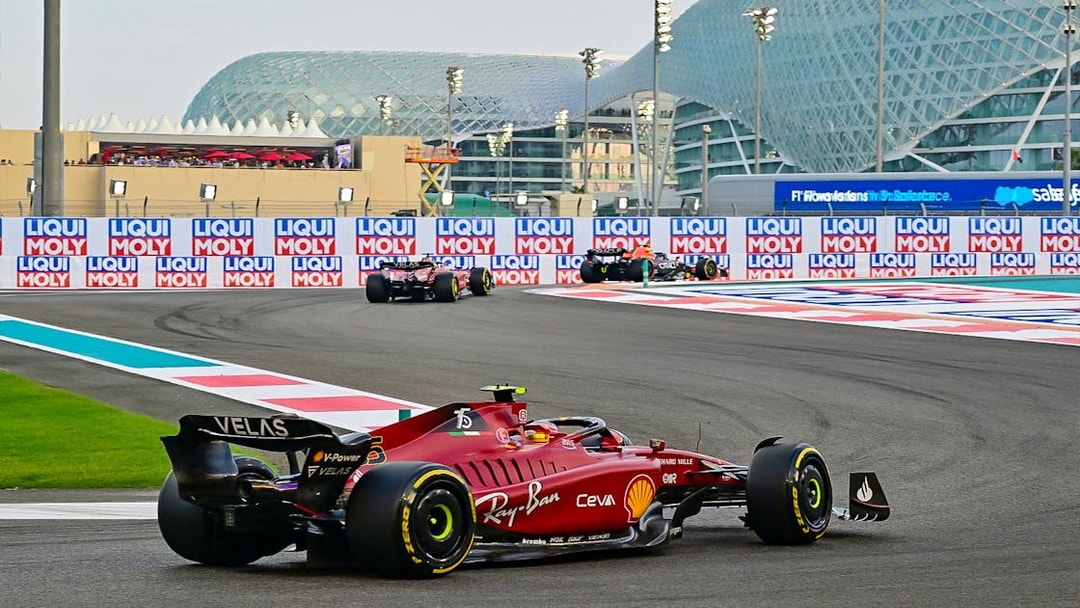 Formula 1 cars racing at Yas Marina Circuit, Abu Dhabi Grand Prix.