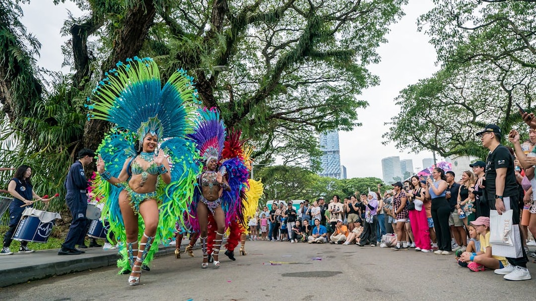Samba dancers performing at F1 Singapore event with a crowd watching.