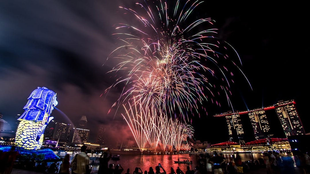 Fireworks display over Marina Bay with Merlion and Marina Bay Sands during F1 Singapore.