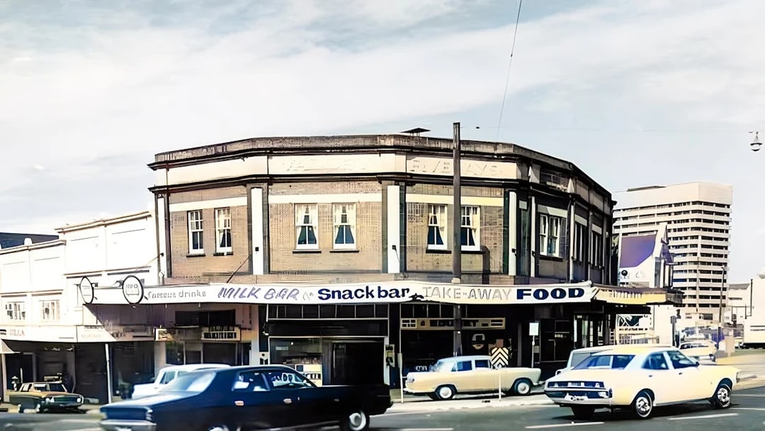 Fortitude Valley street scene with vintage cars and historic milk bar.