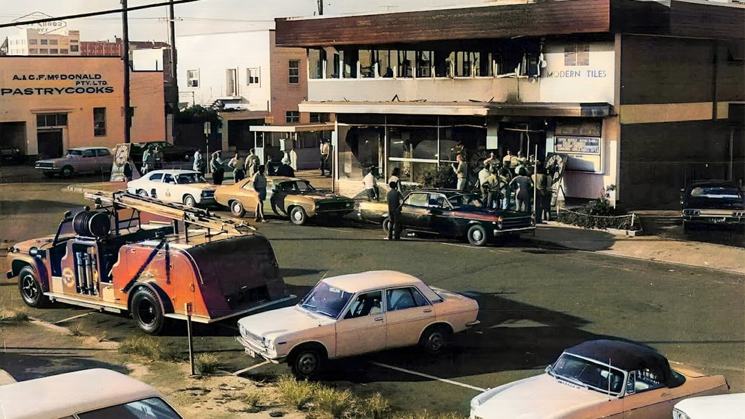 Crowd gathers outside a building in Fortitude Valley during a true crime tour.