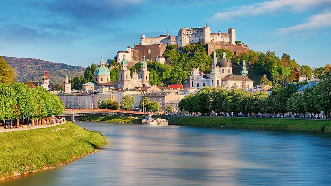 Fortress Hohensalzburg overlooking Salzburg with river and historic buildings.