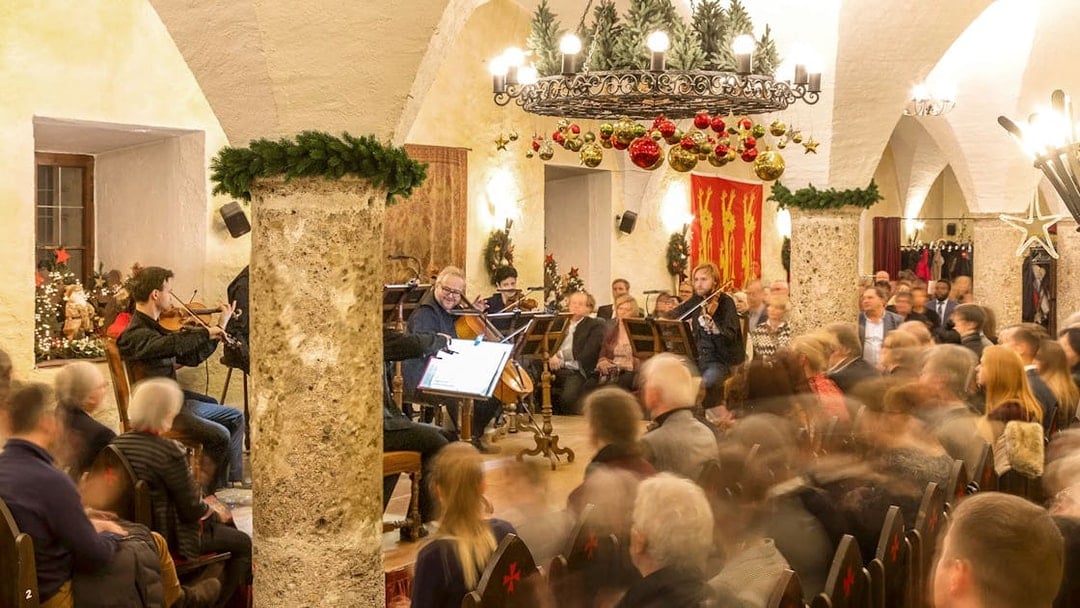 Musicians performing at Fortress Hohensalzburg Christmas Advent concert with audience seated.