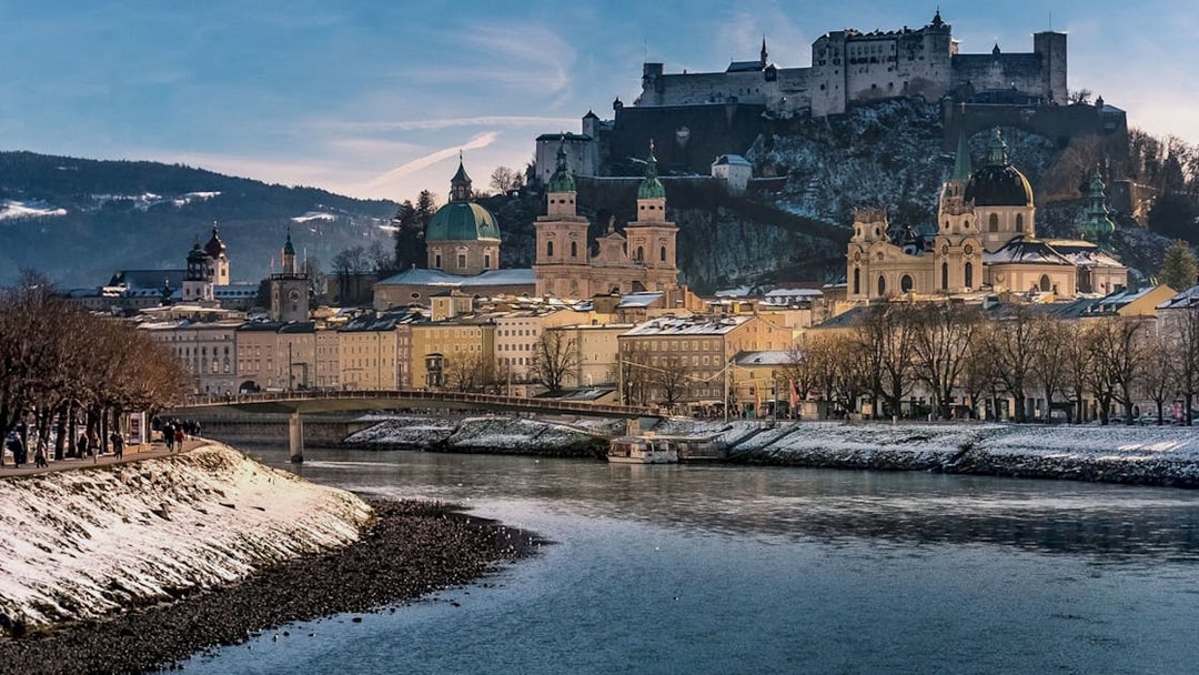 Fortress Hohensalzburg overlooking Salzburg cityscape in winter.