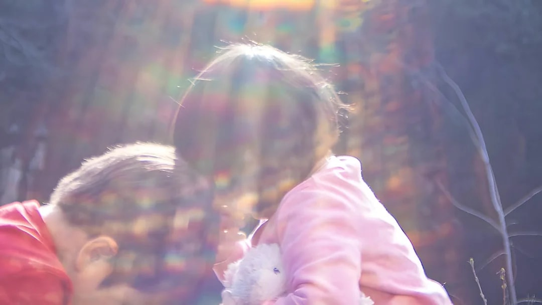 Children playing with a stuffed toy under colorful light at Fotografiska Berlin.