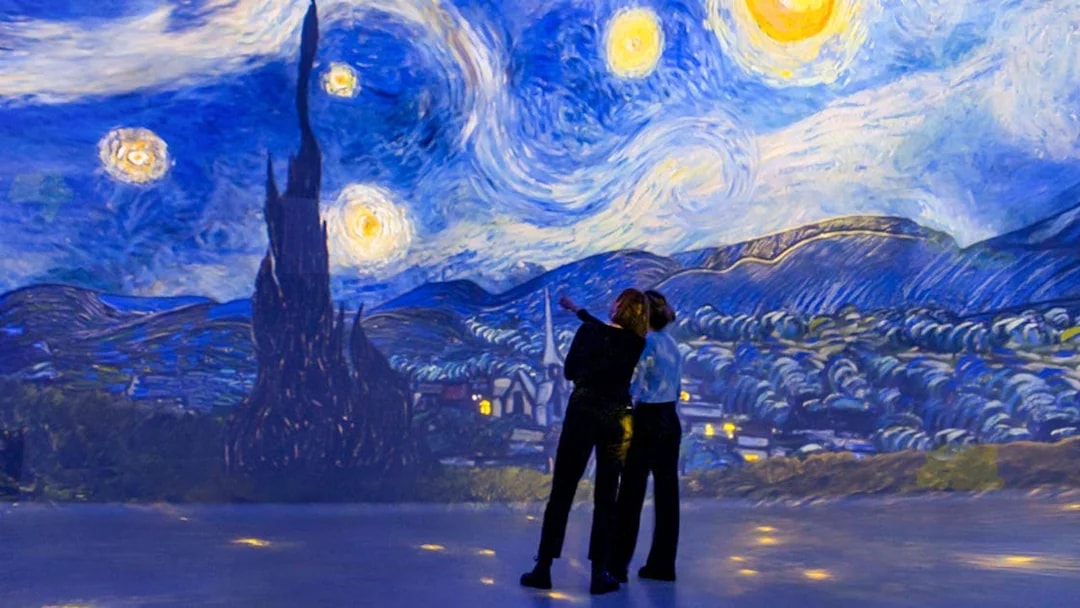 Visitors admire Van Gogh's Starry Night at Frameless Immersive Experience.