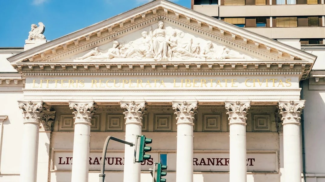 Facade of Literature House in Frankfurt with classical columns and Latin inscription.